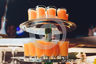 A metal silver tray full of all shot glasses of vodka, gin and tequila clear pure alcohol. party and celebrations. Drink alcohol Stock Photo