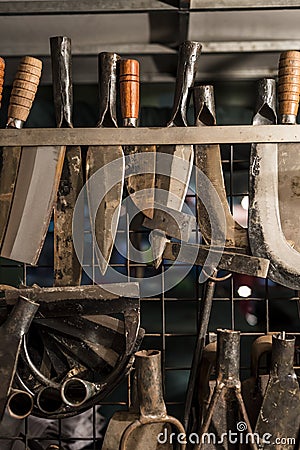 Metal smith sharpening farm tools and knives Stock Photo