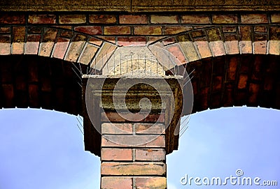 metal spike anti-roosting or bird prevention and repellent strip. pigeon control. brick exterior column Stock Photo