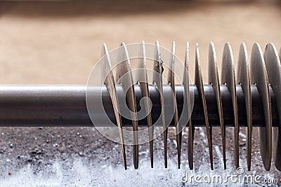 metal spiral before winding on the shaft for auger manufacturing Stock Photo