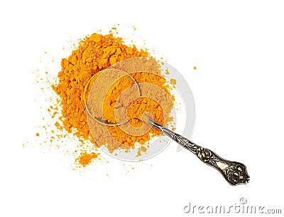 Metal spoon full of yellow turmeric powder Stock Photo