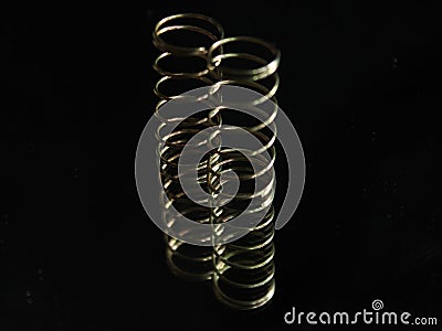 Metal spring round helical spiral reflection elastic Stock Photo