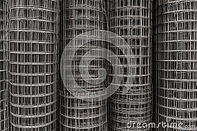 Metal square grid in rolls, steel wire texture, netting fence surface, building material Stock Photo