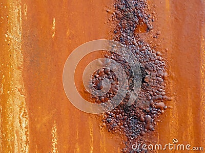 Metal surface with an orange coating that rusts with age Stock Photo