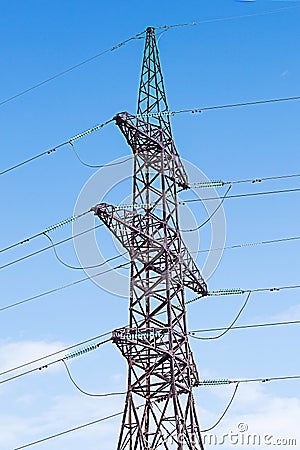 Metal pole of an overhead power line vertically against the sky. Stock Photo