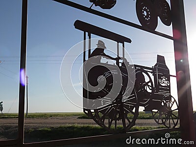 Metal Tractor Sign Silhouetted in the Sunlight Stock Photo