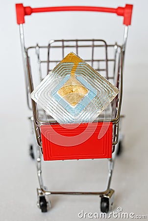 The metal trolley from the supermarket, in which lies the RFID tag. Goods security and alarm. Vertical picture. Close-up Stock Photo