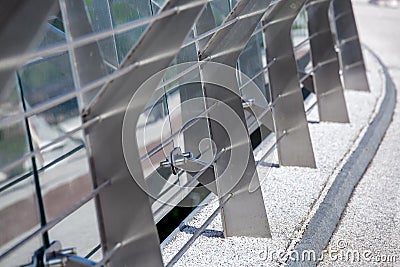 Metal turnbuckles fastening of cables with steel rod on pedestrian bridge. Stock Photo