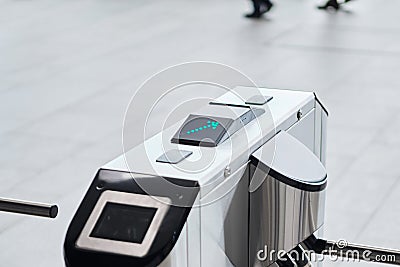 Metal turnstile with forward arrow to signal passage permitted Stock Photo