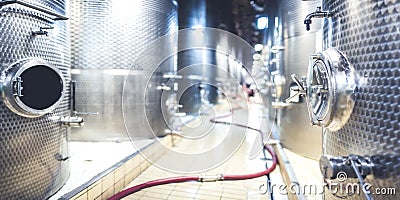 Metal vats for fermentation. Wine factory. Steel barrels in winery. Panorama, banner. Stock Photo