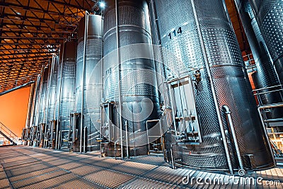 metal vats in which wine or beer is fermented at the factory at the winery. Concept of technologies and equipment for the Stock Photo