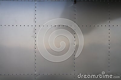 metal wall in background is wall of an airplane fuselage that has been repurposed as residential vehicle. metal wall with metal Stock Photo