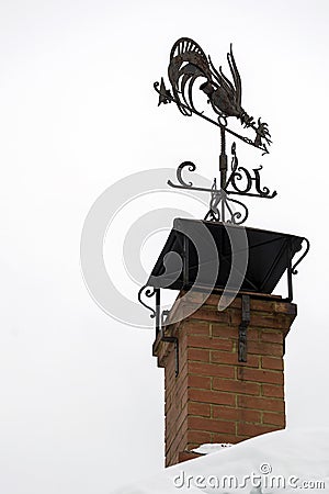 Metal weather vane in the form of a rooster Stock Photo