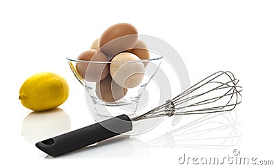 Metal whisk with fresh eggs and lemon Stock Photo