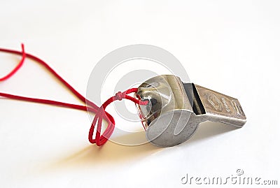 Metal whistle on a red cord Stock Photo