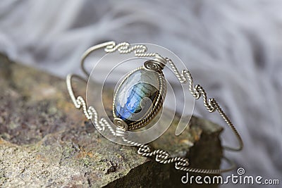 metal wire elegant bracelet on rocky background Stock Photo