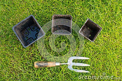 Metal and Wooden Hand Fork and some Plant Pots Stock Photo