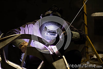Metal workers use manual labor, Skilled welder, Factory workers making OT, The welder is welding the steel in the factory, Welding Stock Photo