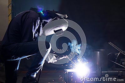 Metal workers use manual labor, Skilled welder, Factory workers making OT, The welder is welding the steel in the factory Stock Photo