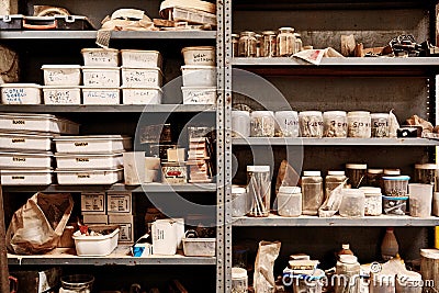 Metal workshop shelves with variety of containers arranged neatl Stock Photo
