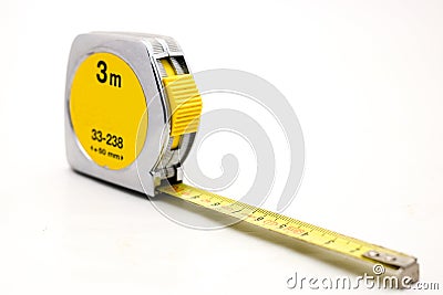 Metal yellow tape measure on white background flexible ruler used to measure distance. Stock Photo