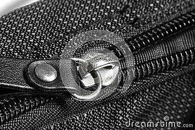 Metal zipper on black synthetic fabric Stock Photo