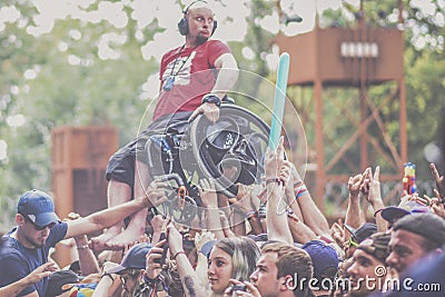 Metalhead in wheelchair during a crowdsurfing at a metal concert Editorial Stock Photo