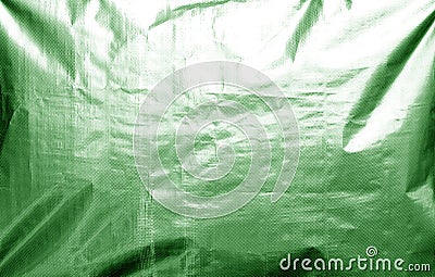 Metalized plasrtic wrap texture with crumples in green tone Stock Photo