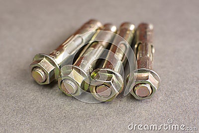 Metallic expansion anchors with zinc coating on gray background Stock Photo