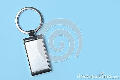 Metallic keychain on light blue background, top view. Space for text Stock Photo