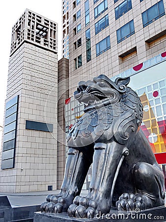 Metallic lion in front of the modern building Stock Photo