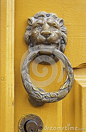 Metallic lion head knocker on a wooden door in Ouro Preto, Brazil Stock Photo