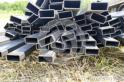 The metallic rectangular profile lies on the construction site Stock Photo