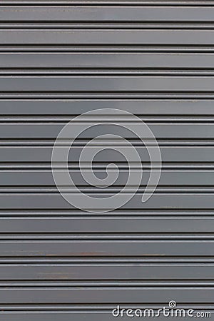 Metallic roll up door. Old Steel rolling shutter background. Stock Photo