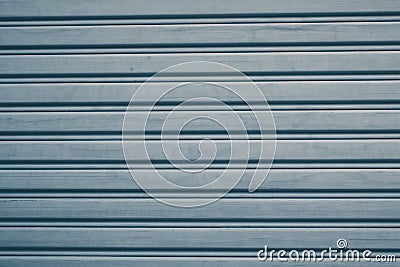 Metallic roll up door. Old Steel rolling shutter background. Stock Photo