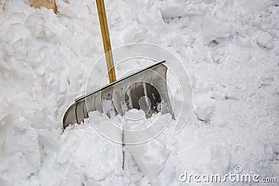 Metallic snow shovel stuck in the snow Stock Photo