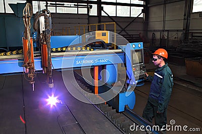 Metalwork Plant, worker controls system thermal cutting of metal Editorial Stock Photo
