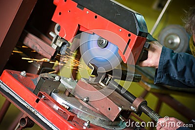 Metalworker cutting metal detail rotary saw Stock Photo
