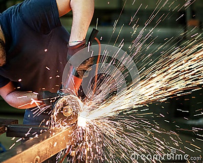 Metalworker cutting a steel bar Stock Photo