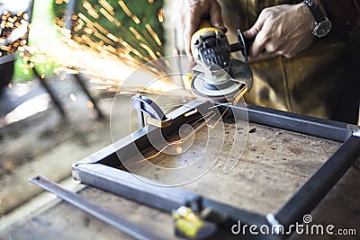 Metalworker with grinder Stock Photo