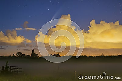 Meteor, shooting star or falling star seen in a night sky with clouds. Comet NEOWISE, C/2020 F3 Stock Photo