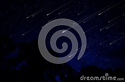 Meteor shower in night sky Stock Photo