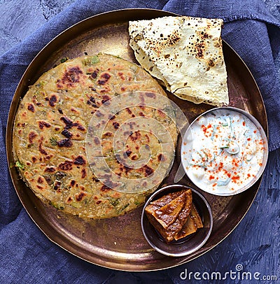 Punjabi thali - Paratha flatbread served with accompaniments Stock Photo