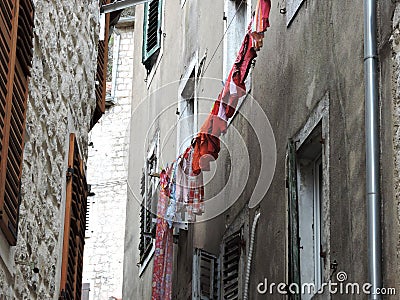 Method for drying laundry in a narrow alley in Mediterranean cities. Stock Photo