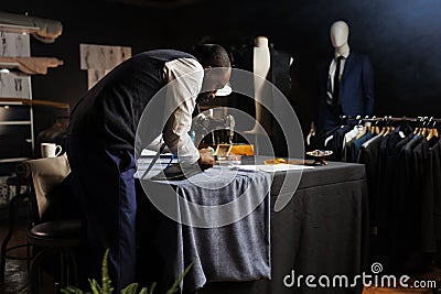 Suitmaker perfecting comissioned suit Stock Photo