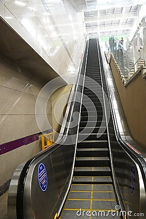 Metro escalators going upwards, in delhi. Escalator stepping towards the exit gate. Editorial Stock Photo