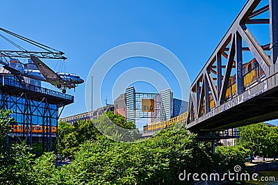 Metro train operated by Berliner Verkehrsbetriebe on a historic bridge. Lefthand a historic aircraft from the Museum of Technology Editorial Stock Photo