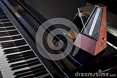 Metronome on a grand piano Stock Photo