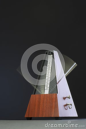 Metronome in motion Stock Photo