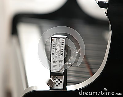 A metronome on a piano Stock Photo